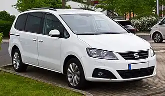 Front three-quarter view of a five-door road car with sliding rear-passenger doors.