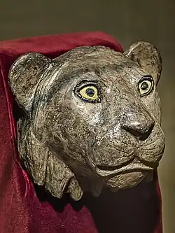 Silver lioness head finial for the arm of a chair with shell and lapis lazuli inset eyes, recovered from the royal cemetery of Ur 2550–2450 BCE, from the death pit at the entrance to Puabi's chamber[22]