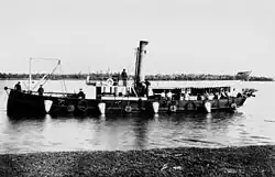 Submarine minefield service vessel "Miner" with conical mines and connecting cables hanging over side[gallery 8]