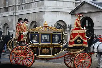 Queen Elizabeth II approaches Horse Guards in the Irish State Coach following the State Opening of Parliament in 2008.