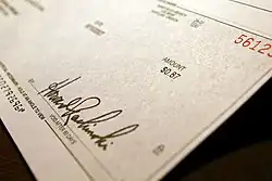 Image 9A check, used as a means of converting funds in a demand deposit to cash (from Money)