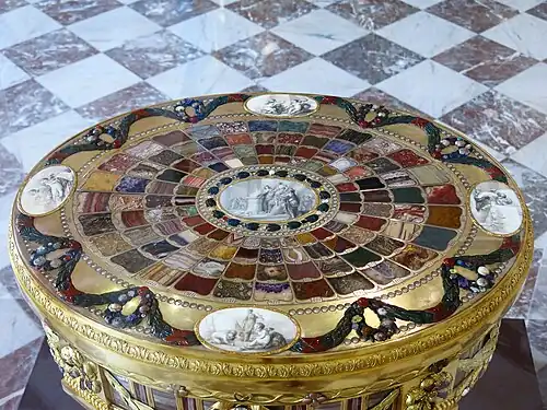Louis XVI style festoons on the Table de Teschen, by Johann Christian Neuber, 1775–1800, gilt bronze, semiprecious stones, porcelain, and wood, Louvre[9]