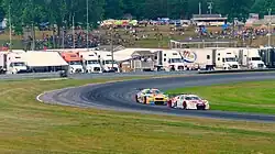 GT3 cars battle through "The Left Hander", turn 3, headed up towards Paul Newman Straight during an IMSA event at Lime Rock Park