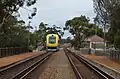 Passenger train stopped at small side platform