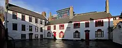 Low yard, adjacent to the main complex: part of the former School (left, rebuilt 1753) and more almshouses (1782).