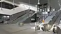 The Interior, wiith two escalators, stairs, and a lift.