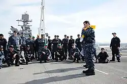 YN2 Thomas Jones demonstrates life preserver inflation during "abandon ship" drill aboard USS Makin Island (LHD-8).