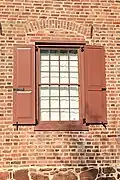 South wall Flemish bond brickwork, brownstone foundation, and iron beam anchors