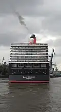 Moving forward very slowly (against the tide), the ship approaches the dry dock.