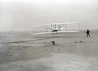 An airplane flying on a beach