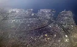 An aerial view north-west of the Port of Chiba (Cosmo Chiba refinery seen left of the river mouth)
